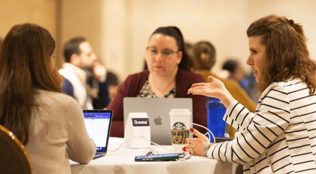 A gallery of photos showing meetings and activities with employees working at Qventus