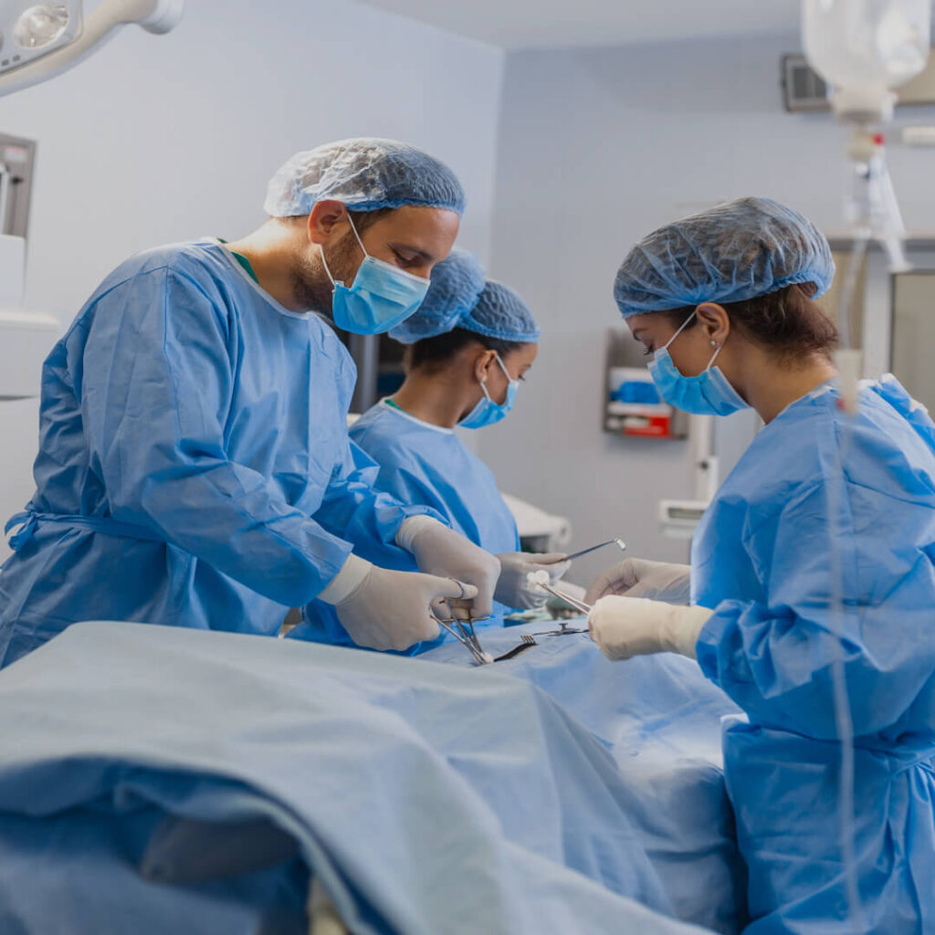 Surgical professionals walk down a hallway in a hospital facility representing UAMS