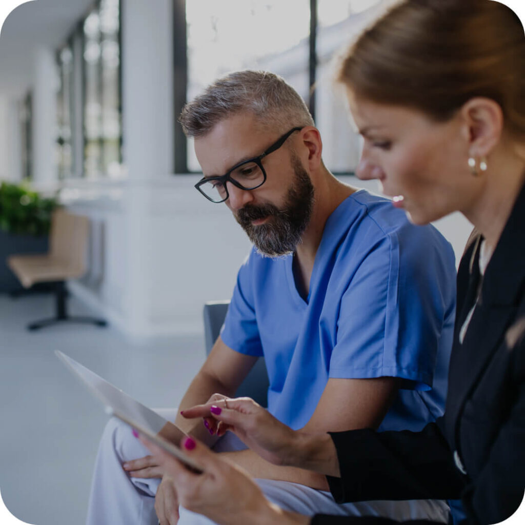 Two healthcare professionals review a surgical plan at a facility representing UAMS