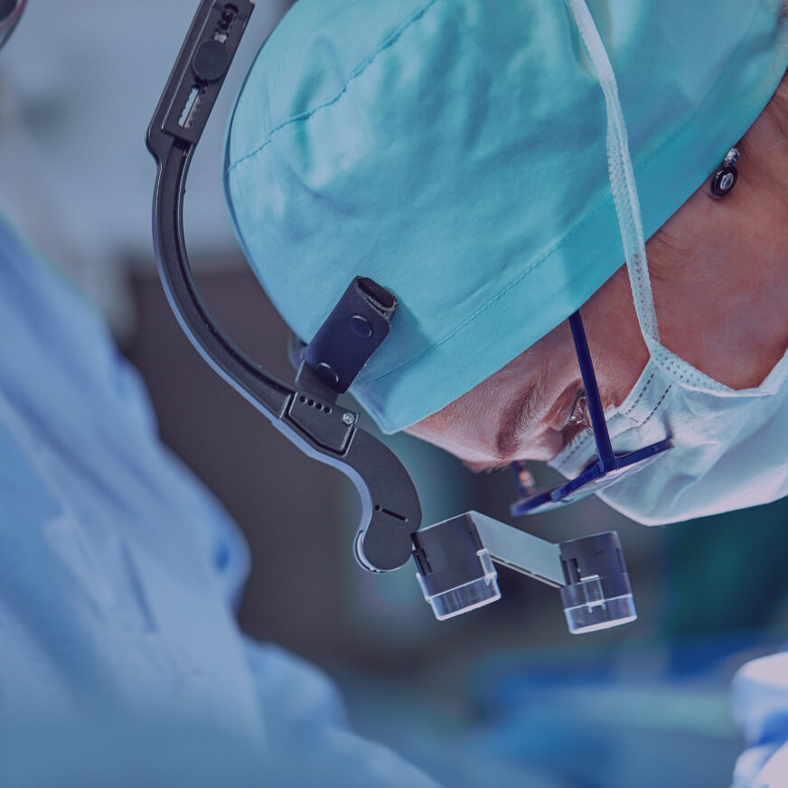 A close-up view of a surgeon in a headlamp who represents the surgical services team at M Health Fairview